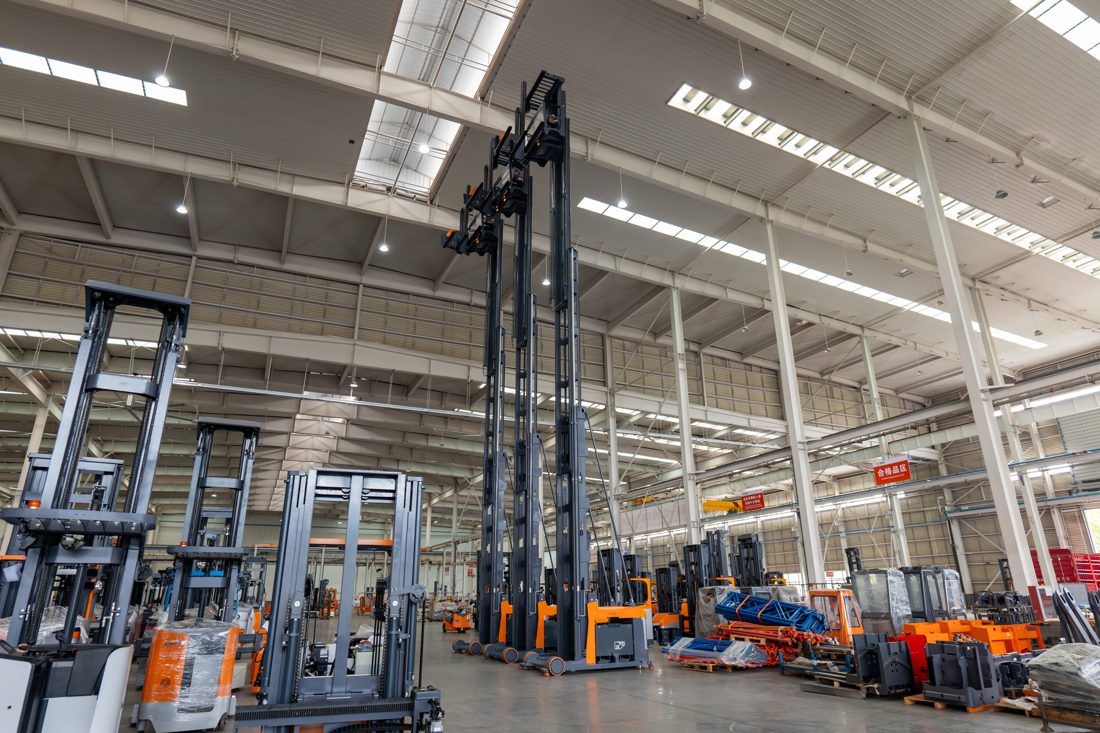 A mixed fleet of forklifts of several brands parked in a Singapore yard