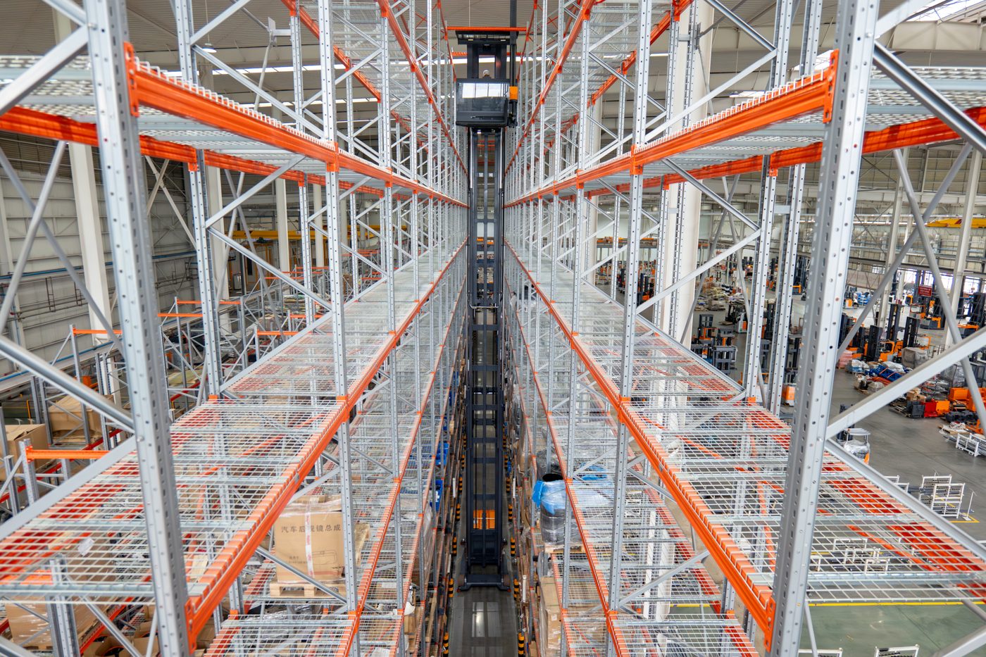 Looking up a very narrow aisle showing high-density VNA racking