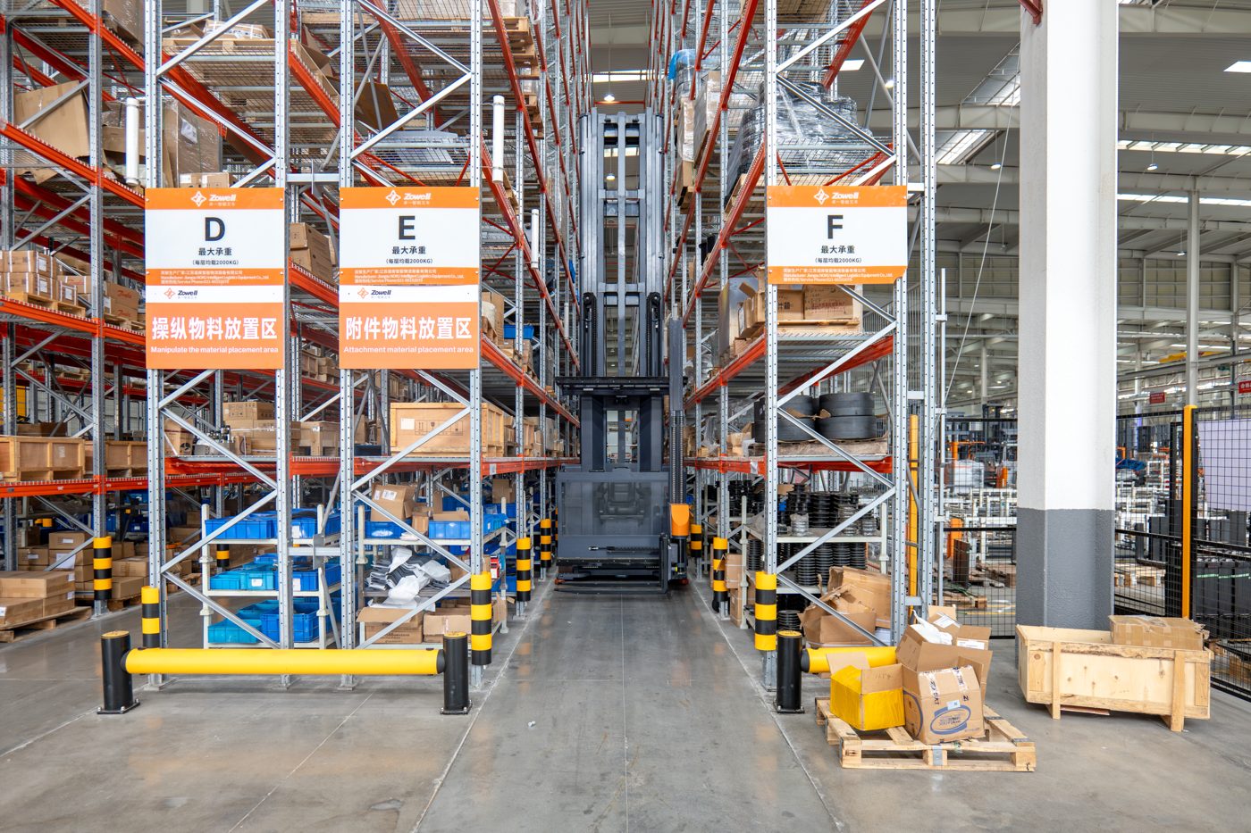 Zowell VNA man-up forklift working in a very narrow aisle between tall warehouse racking in Singapore
