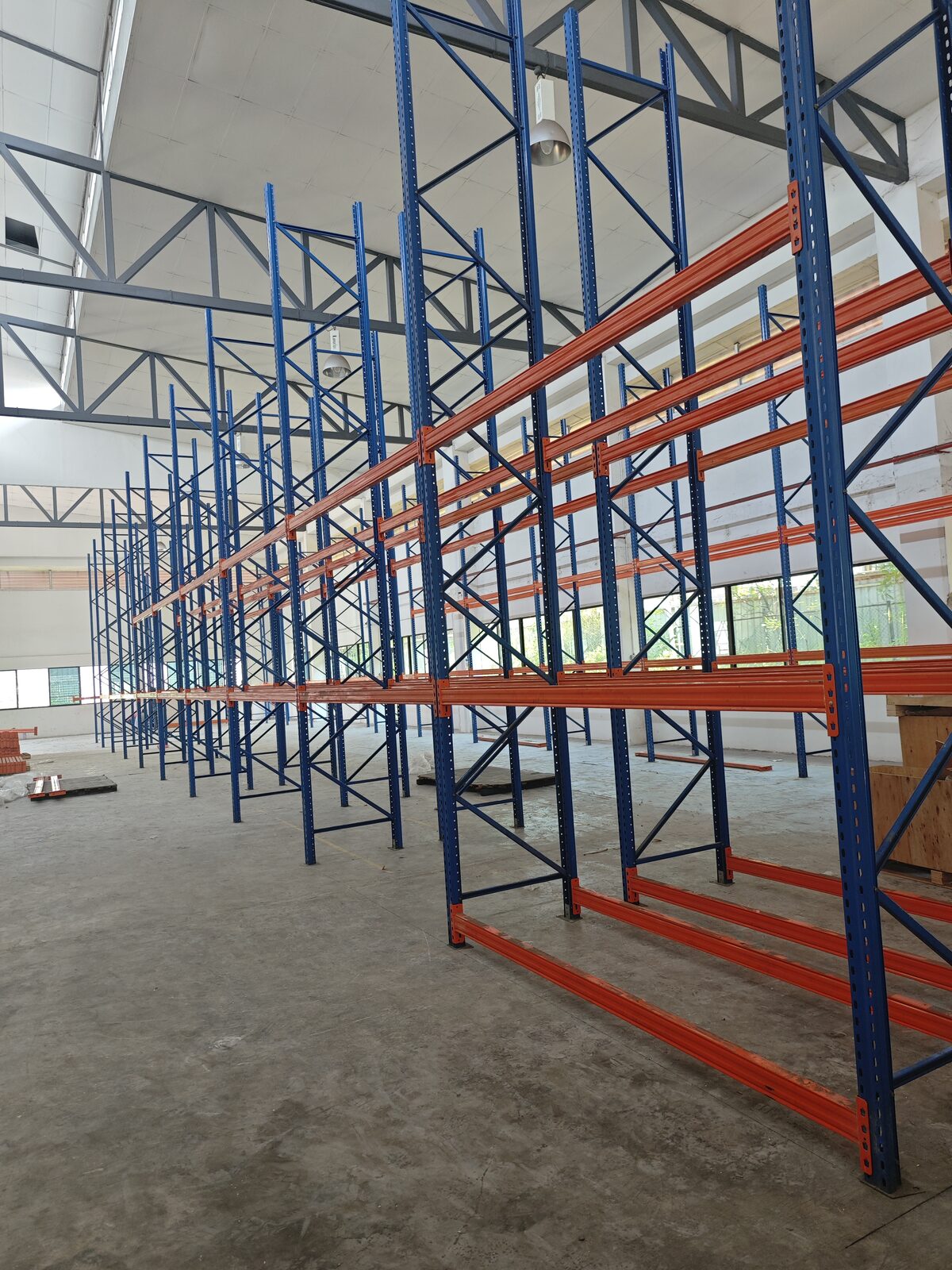 Forklift lifting a pallet to high racking